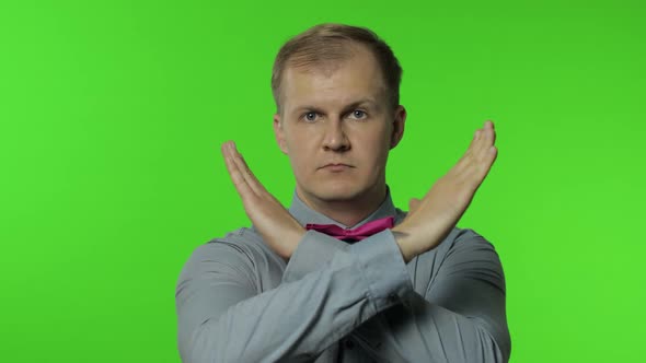 Man Crossed His Arms in X Sign and Saying No, Warning of Finish, Prohibited Access. Telling To Stop alt