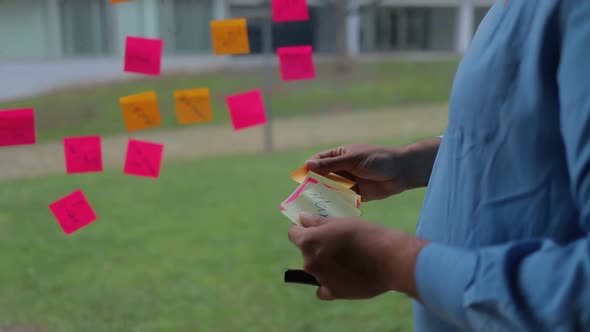 Male Hands Glueing Sticky Notes on Window. alt