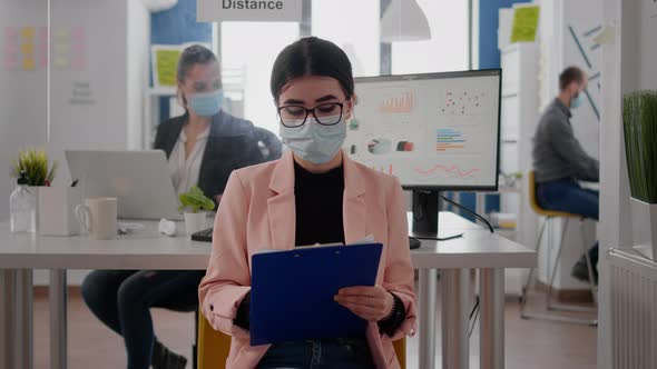 Front View of Businesswoman Wearing Face Mask While Talking on Online Video Call Meeting alt