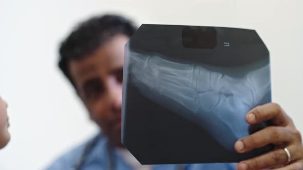 Doctor Explaining Leg Injury to Little Girl alt