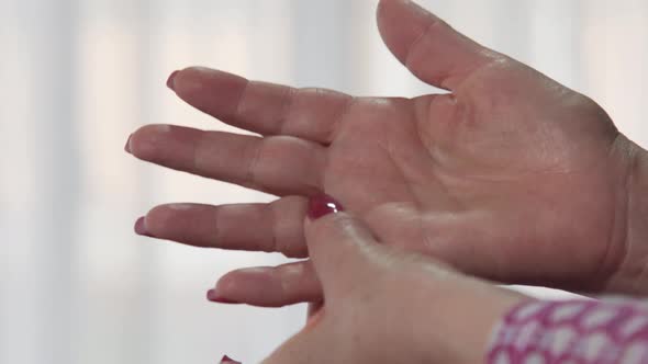 woman hands removing engagement ring from finger