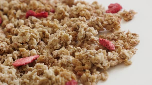 Panning over muesli with dehydrated strawberries  4K 2160p 30fps UltraHD footage - Tasty and  crunch alt