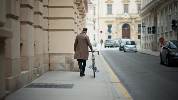 Young Business Manager Going to Work on Bike