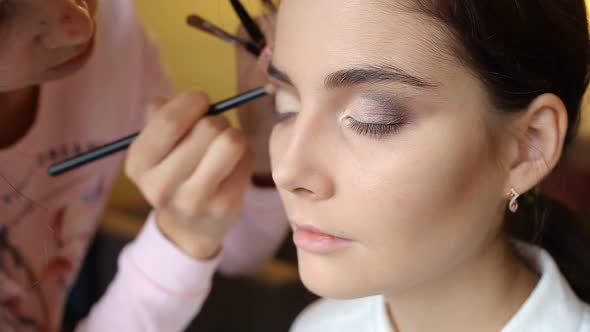 Makeup artist makes a girl beautiful makeup