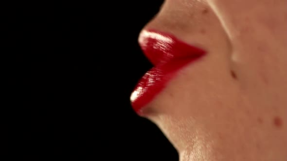Kisses by woman mouth close up