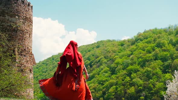 A Girl in a National Georgian Red Dress is Dancing alt