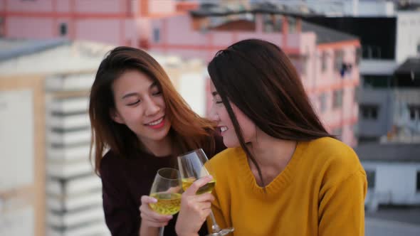 Young asian girl friends hanging out with drinks. Holiday celebration festive party. alt