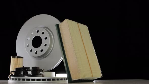 New Car Brake Discs and Pads on a Black Background alt