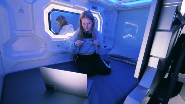 Teenage Girl is Going to Sleep in a Capsule Guest Room alt