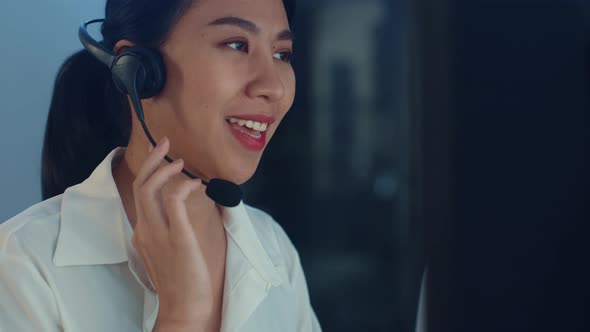 Asia young call center team or customer support service executive using computer and microphone.