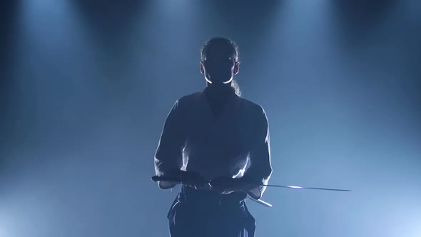 Man Fighting at Aikido Training with Japanese Sword Katana in Martial Arts School. Healthy Lifestyle alt