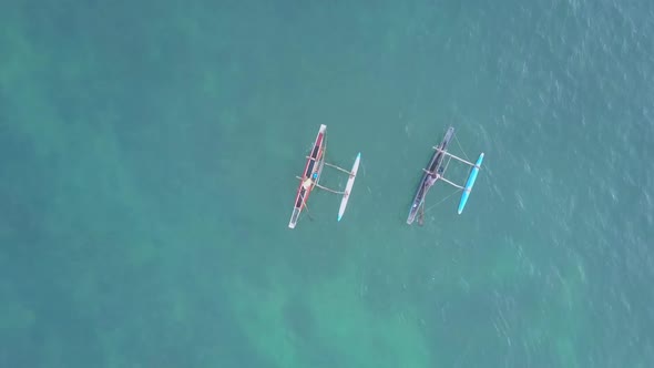 Asian People Sail on Long Canoes Along Azure Sea Aerial View alt