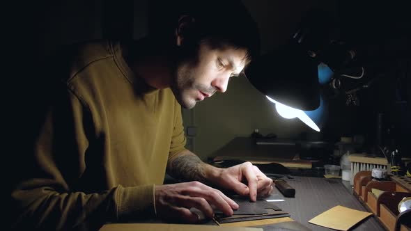 Person Tailor Who Works with Leather in Workplace alt