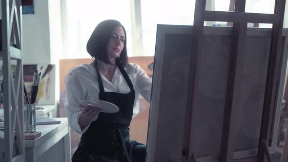 Beautiful Female Painter Drawing Picture in Art Studio