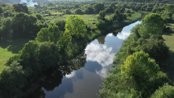 River With Sky Reflections In Forest Aerial View