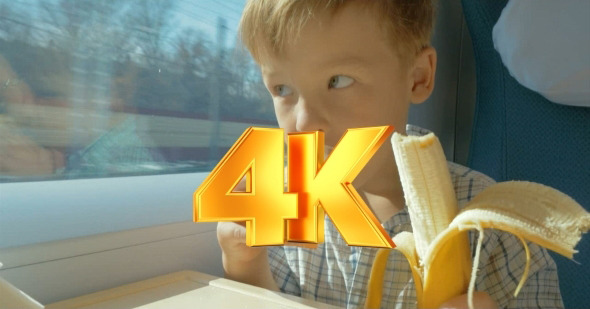 Little Boy Eats While Travelling By Train  alt