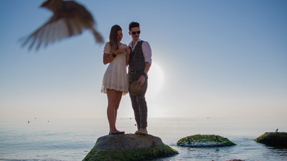 Couple On Rocks In Water alt