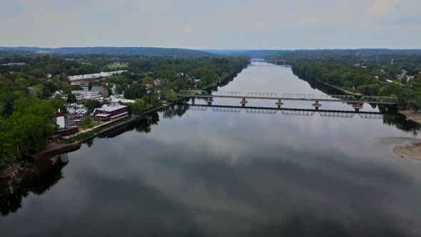 Overhead View of Delaware River on Bridge Across Aerial Landscape of Small Town with Historic City alt