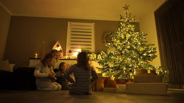 Parents With Children at Christmas Tree