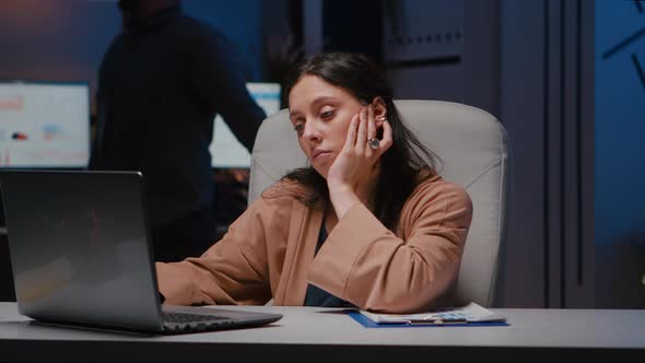 Portrait of Exhausted Workaholic Manager Checking Economic Statistics Using Laptop Computer alt
