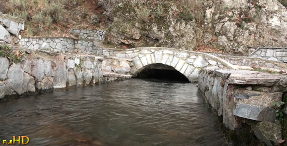 Stream of Water Passes under a Small Stone Bridge