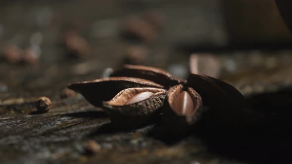 Anise and peppercorns on old wooden surface in kitchen used for spicing food. 4K alt