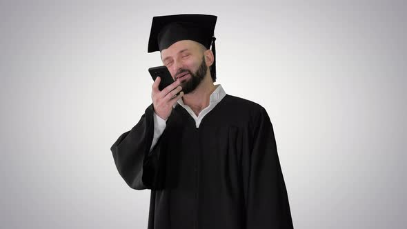Mature Man Graduate Student Making Speakerphone Call on Gradient Background. alt