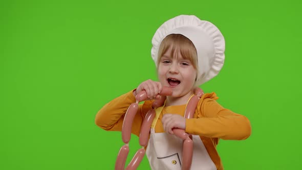 Teen Child Girl Dressed As Cook Chef in Apron Dancing with Sausages Fooling Around on Chroma Key alt