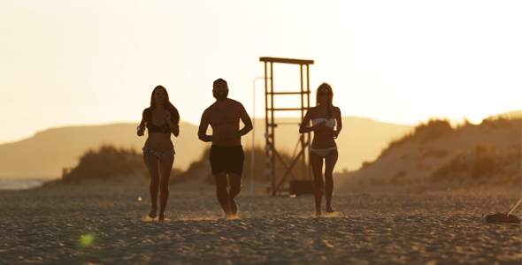 Happy Young People Running on Sandy Beach 2