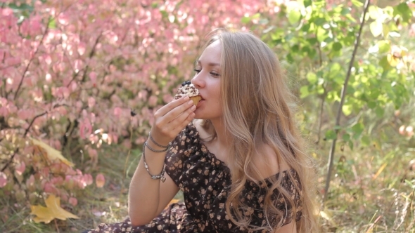 Young Girls Eating Cupcake And Smile Autumn