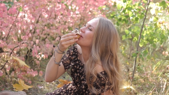 Young Girls Eating Cupcake And Smile Autumn