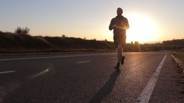 Young Man Running Outdoors In The Morning.