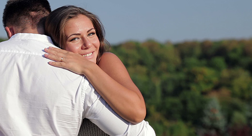 Husband and his pregnant wife relaxing in autumn park
