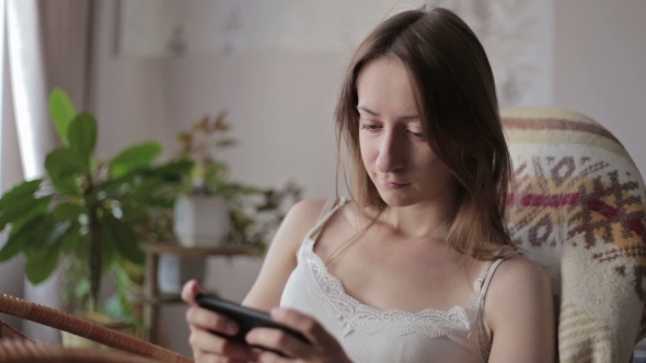 Young Beautiful Woman Sitting With Smart Phone.
