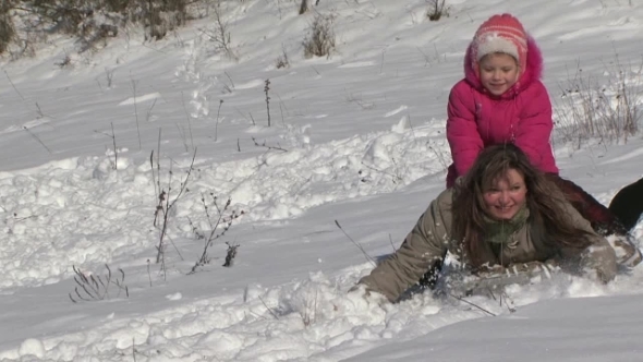 Girl Riding A Mother With A Snow Slide