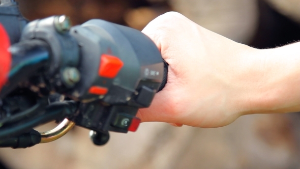 Biker's Hand On The Right Grip Of The Motorcycle alt