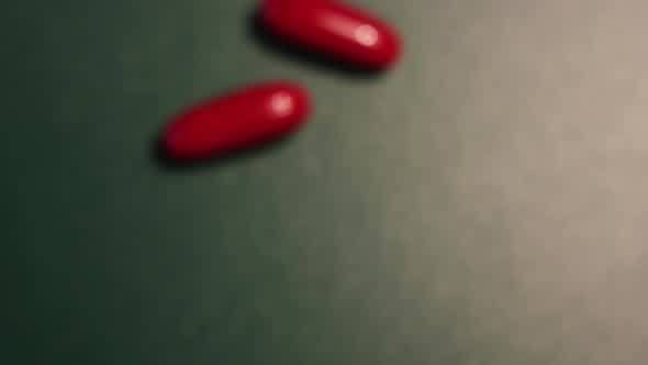 Hands Taking Red Pill From a Pack