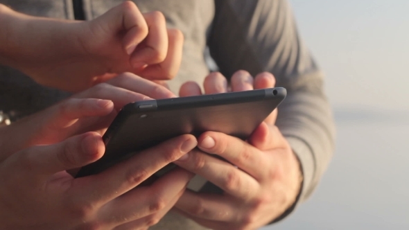 Young Mans Hands Touch a Tablet.