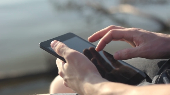 Young Man Working Outdoors With Tablet.