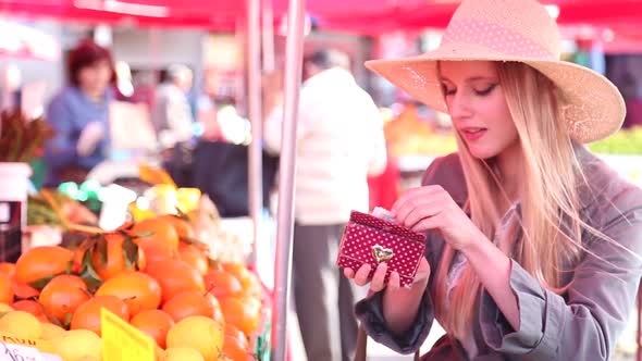 Beautiful Girl At The Market Paying For Fruit alt