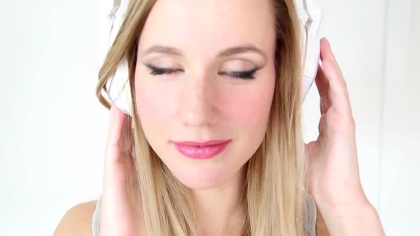 Beautiful Young Blond Woman Dancing With White Headphones 32 alt