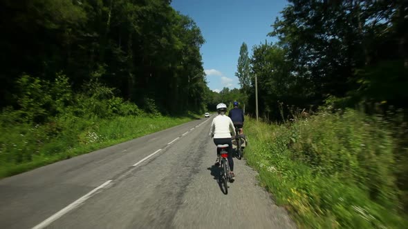 Slow Motion - Retired Couple Cycling On Road In Village In France 4 alt