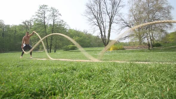 Strong Muscular Man Exercising With Ropes 6 alt