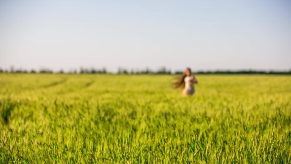 Happy Girl Running In Green Field