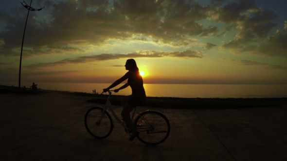 Girl On Bicycle At Sunset