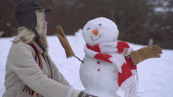 Cute Winter Girl Hugs and Kisses Snowman alt