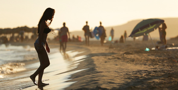 Young Woman In Bikini Walking On The Beach 2