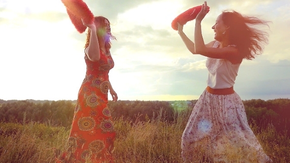 Two Beautiful Girl Friends Pillow Fight On Nature