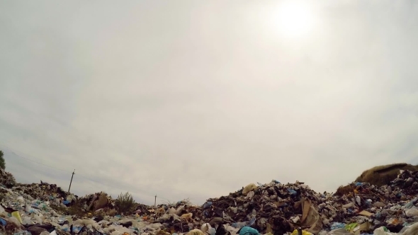 Sun In Grey Sky Over Garbage Dump In Ukraine