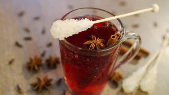 Mulled wine in a mug with clove, cinnamon and